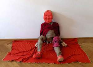 Roza El Hassan 2007: Red Man. Wood, textile, plaster, 33 x 32 x 43 inches (83 x 81 x 109 cm approx)